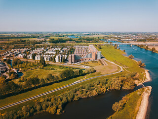 Aerial drone shot of the suburban near the big river in the Netherlands. 