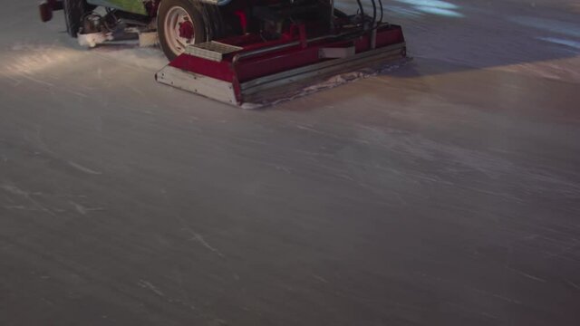 Ice resurfacer at night on ice.  A machine for polishing snow on ice in the city center on Christmas night.