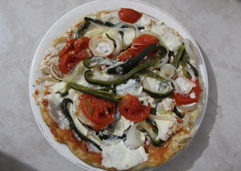 Individual homemade pizza, with vegetables.