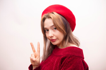 Young beautiful girl in a red beret isolated on a white background
