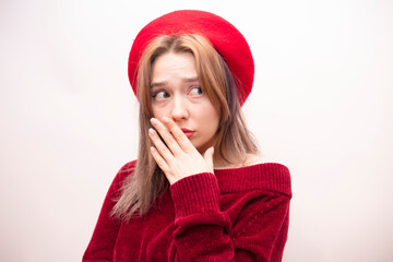 Young beautiful girl in a red beret isolated on a white background