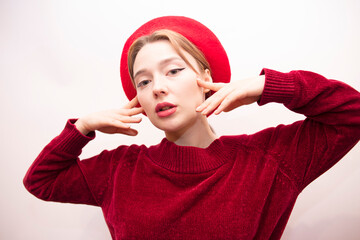 Young beautiful girl in a red beret isolated on a white background