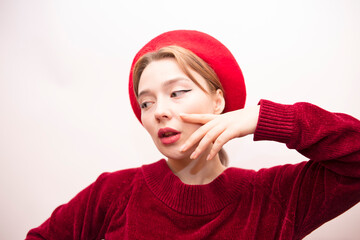 Young beautiful girl in a red beret isolated on a white background
