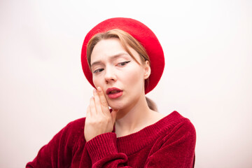 Young beautiful girl in a red beret isolated on a white background
