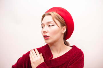 Young beautiful girl in a red beret isolated on a white background
