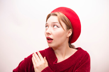 Young beautiful girl in a red beret isolated on a white background