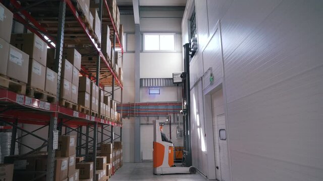 the loader lifts the goods onto the warehouse shelves