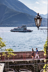 Small ferry sails on Lake Como