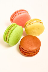 Delicious multicolored macaroons on white background.