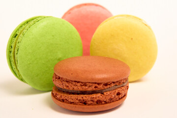 Delicious multicolored macaroons on white background.