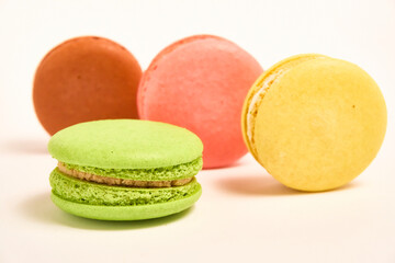 Delicious multicolored macaroons on white background.