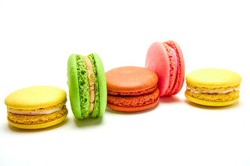 Delicious multicolored macaroons on white background.