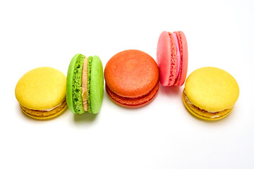 Delicious multicolored macaroons on white background.