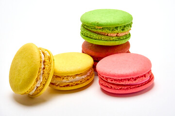 Delicious multicolored macaroons on white background.