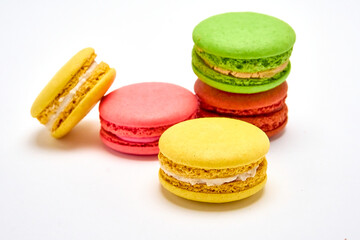 Delicious multicolored macaroons on white background.