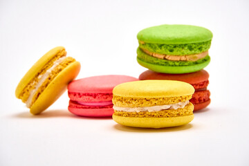 Delicious multicolored macaroons on white background.