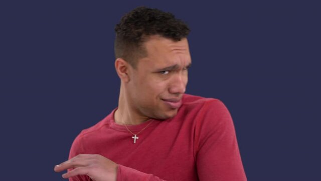 Handsome multiethnic man retracks in disgust at what he is hearing or seeing