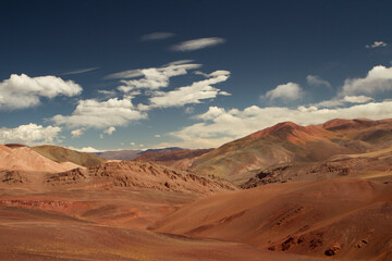 Fototapeta na wymiar Desert landscape high in the Andes mountain range. View of the brown land and colorful mountains in Laguna Brava, La Rioja, Argentina.