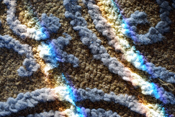 close up of a carpet with light