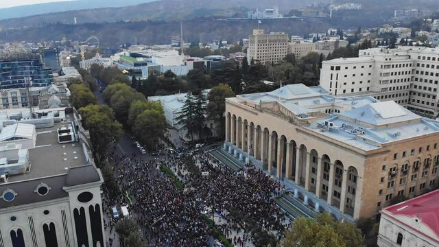 1st november, 2020. Tbilisi.Georgia.Ascending front Aerial view down to crowds of perople gathered protesting in front of parliament building.Post parliament election protests in caucasus.