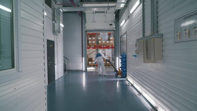 worker uses a stacker in a warehouse