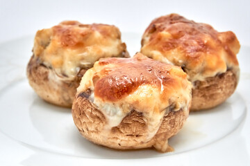 Champignons stuffed with cheese, chicken baked in the oven.