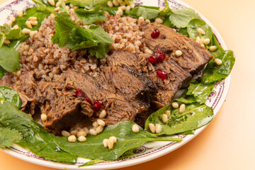 Dish with baked beef meat and buckwheat porridge