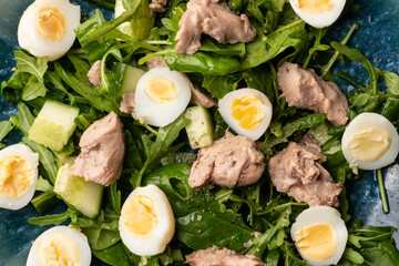 Closeup view of salad view quail eggs, .arugula and cod liver