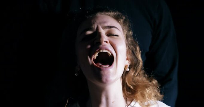 Domestic violence, the rapist covers the victim's mouth, the woman screams