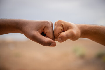 Fists of different colors against each other 