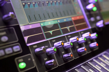 Sound engineer mixing console at work.