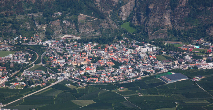 Panoramic view of Schlanders village and apple orchards in the Vinschgau valley, South Tyrol in Italy