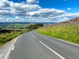 View down, Slaidburn Road, with hills and valleys, in the far distance in, Slaiburn, Clitheroe, UK