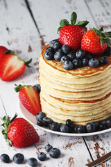 A stack if home-made pancakes with berry