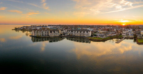 Aerial sunset panorama of Havre de Grace Maryland with orange sky and clouds reflecting on the...