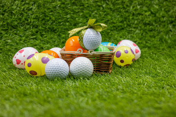 Golf ball for Easter Holiday with Easter Eggs on green grass