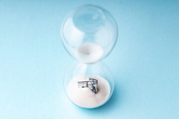 Global economic crisis concept. Dollar bill in hourglass. Financial market recession period. Devaluation of money concept, Inflation idea.