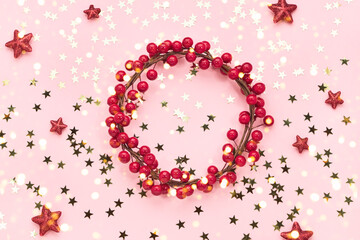 Christmas background. Red Christmas decoration on pink background. Copy space