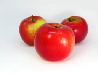 Three freshness red apples on white background.