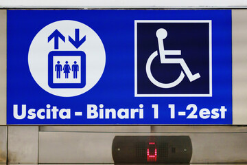 Closeup sign board shows direction to railway train station platform 1, platform 2 and exit on lift...