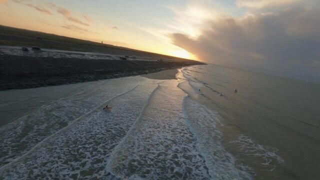 A beautiful aerial shot of the whole shoreline with surfers in Domburg, the Netherlands
