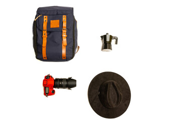 Simple camping kit for hiking in the mountains, including a blue backpack with leather straps, a camera, a black Italian coffee maker and a hat, on a white background