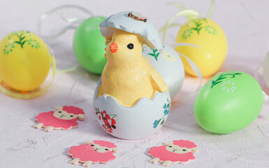 easter eggs and chicken.
Easter chicken, eggs and lamb on a pink background, close-up side view.