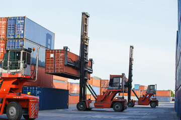 Container loading in container yard with container handlers. Container ship in import and export business logistic company. Business Logistics and Transportation concept.