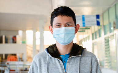 Man wearing a medicine mask in business public area protect himself from risk of disease, people prevent infection from coronavirus Covid-19 or Air pollution