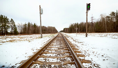 Railroad in winter, semaphore lights up green