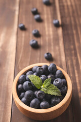 blueberries in a wooden bowl on table