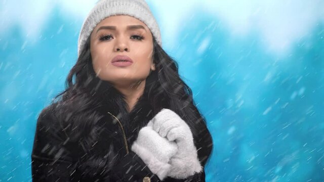 Beautiful Asian woman stuck out in snowy cold weather looks for assistance
