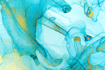 Naklejka premium Chaotically splattered blue transparent ink stains. Abstract watercolor background with gold splashes.