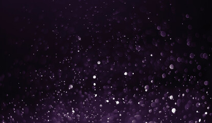 Abstract purple dust dark background. Bokeh blur, glitter defocused on black background.